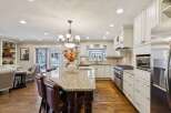 Step into this stunning kitchen, the heart of the home, featuring a spacious island with seating, perfect for entertaining.