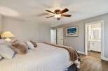 Step into this inviting bedroom, featuring a cozy bed adorned with plush pillows and a warm, inviting blanket.