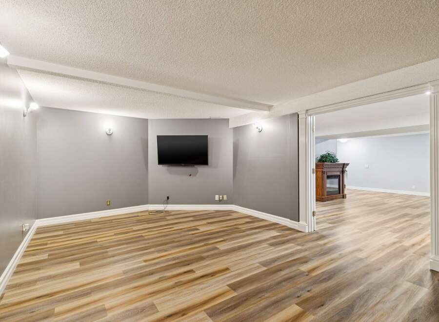 Step into this inviting space, featuring a modern design with a mounted TV, perfect for entertainment.
