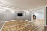Step into this inviting space, featuring a modern design with a mounted TV, perfect for entertainment.