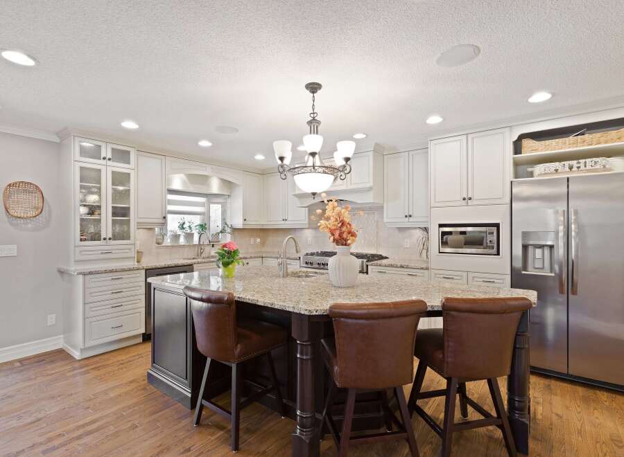 This stunning kitchen boasts a spacious island with seating, perfect for entertaining or casual dining.