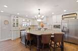 This stunning kitchen boasts a spacious island with seating, perfect for entertaining or casual dining.
