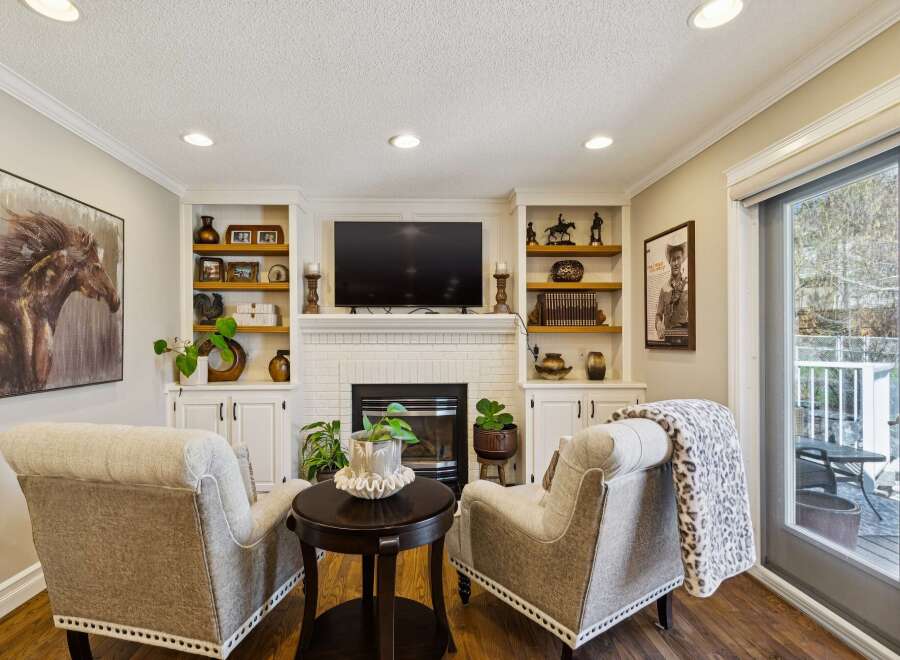This stunning living room features a cozy seating area with two armchairs and a round coffee table, perfect for relaxing or entertaining.