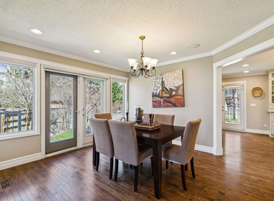 Step into this elegant dining room, featuring a dark wood dining table and comfortable upholstered chairs.