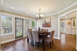 Step into this elegant dining room, featuring a dark wood dining table and comfortable upholstered chairs.
