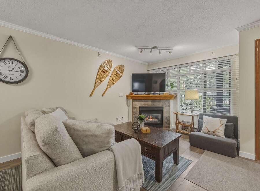 Cozy up in this charming living room featuring a fireplace, perfect for those chilly evenings.