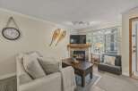 Cozy up in this charming living room featuring a fireplace, perfect for those chilly evenings.