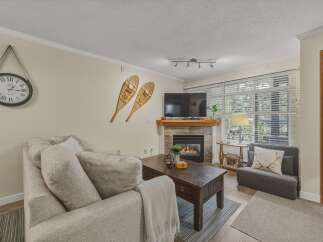 Cozy up in this charming living room featuring a fireplace, perfect for those chilly evenings.