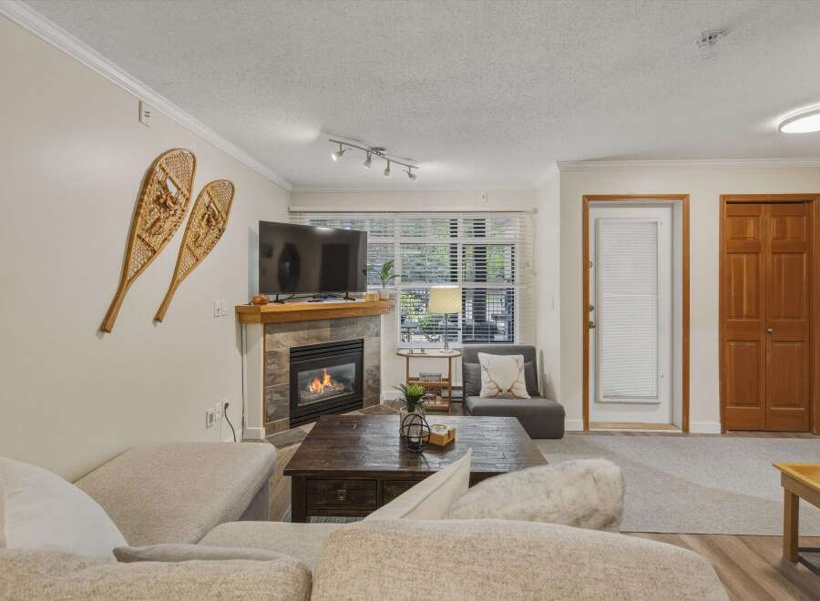 Cozy up in this inviting living room, complete with a fireplace and a comfortable seating area.