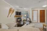 Cozy up in this inviting living room, complete with a fireplace and a comfortable seating area.