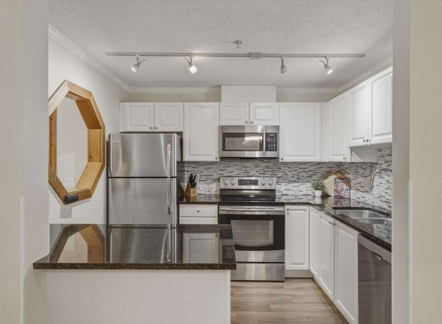 This stunning kitchen boasts modern appliances and sleek countertops, perfect for culinary enthusiasts.