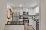 This stunning kitchen boasts modern appliances and sleek countertops, perfect for culinary enthusiasts.