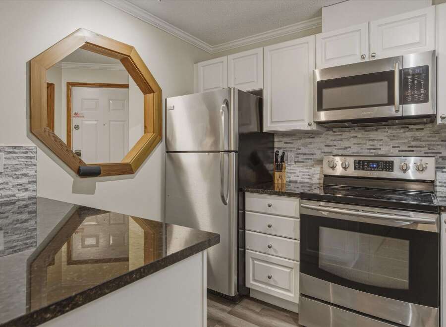 This stunning kitchen boasts modern appliances and ample counter space, perfect for culinary enthusiasts.