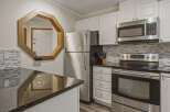 This stunning kitchen boasts modern appliances and ample counter space, perfect for culinary enthusiasts.