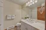 This beautiful bathroom features a modern vanity with a marble countertop, providing a luxurious and stylish space.