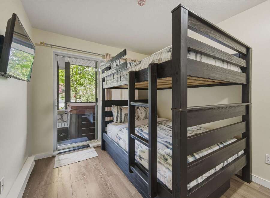 This cozy bedroom features a stylish bunk bed, perfect for accommodating guests or family members.