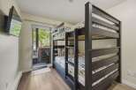 This cozy bedroom features a stylish bunk bed, perfect for accommodating guests or family members.