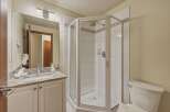 This beautiful bathroom features a modern shower with glass doors, perfect for a refreshing start to your day.