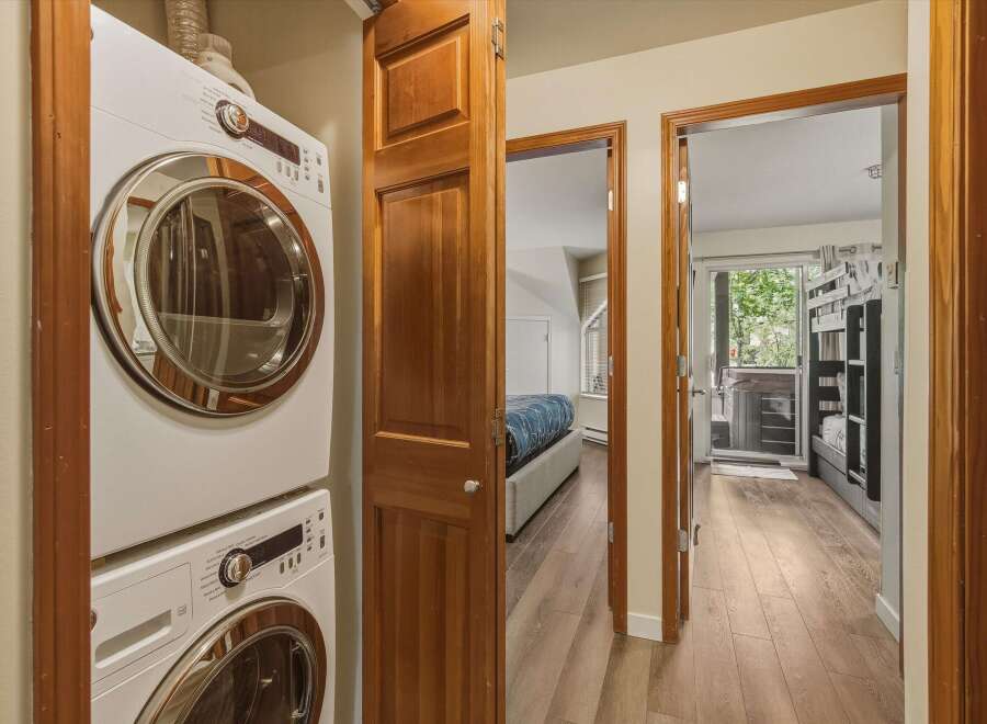 Discover a beautifully designed home featuring a convenient laundry area with a modern washer and dryer.