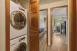 Discover a beautifully designed home featuring a convenient laundry area with a modern washer and dryer.