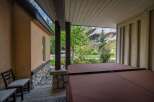 Enjoy the tranquility of this stunning property featuring a covered patio with a hot tub, perfect for relaxation.