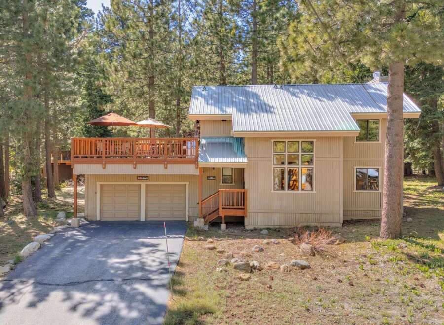 Nestled amidst towering trees, this stunning property offers a tranquil retreat.
