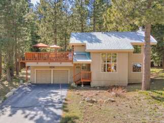 Nestled amidst towering trees, this stunning property offers a tranquil retreat.