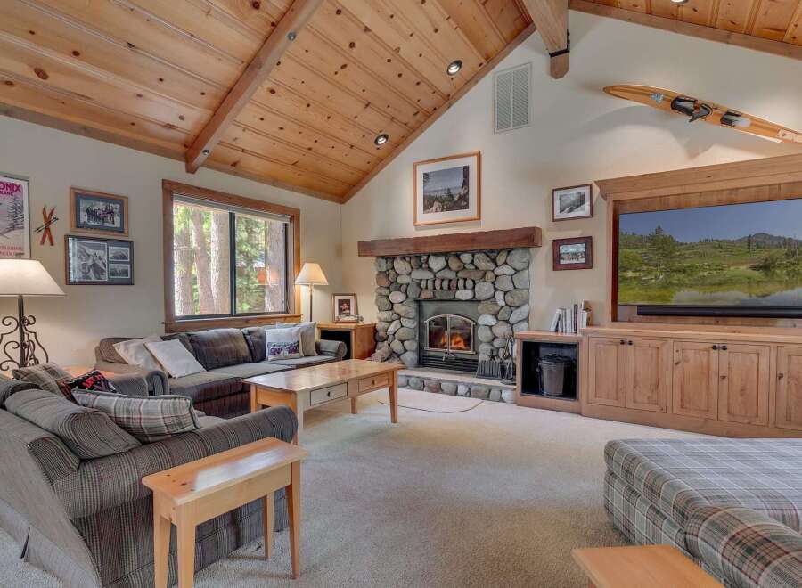 Step into a cozy living room with a stunning stone fireplace, perfect for those chilly evenings.