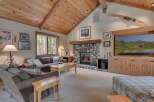 Step into a cozy living room with a stunning stone fireplace, perfect for those chilly evenings.