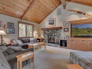 Step into a cozy living room with a stunning stone fireplace, perfect for those chilly evenings.