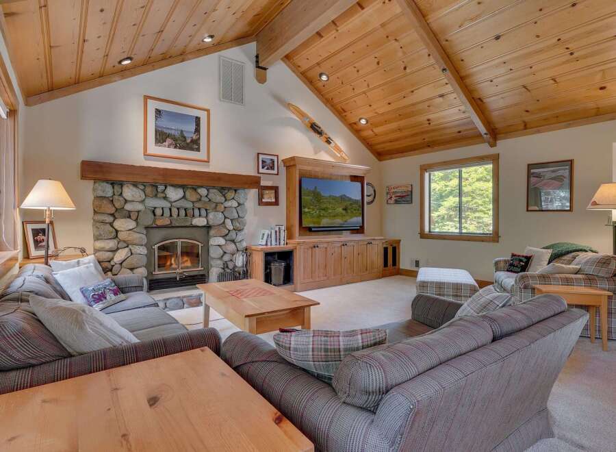 This stunning living room boasts a cozy stone fireplace, perfect for chilly evenings.