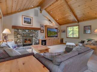This stunning living room boasts a cozy stone fireplace, perfect for chilly evenings.