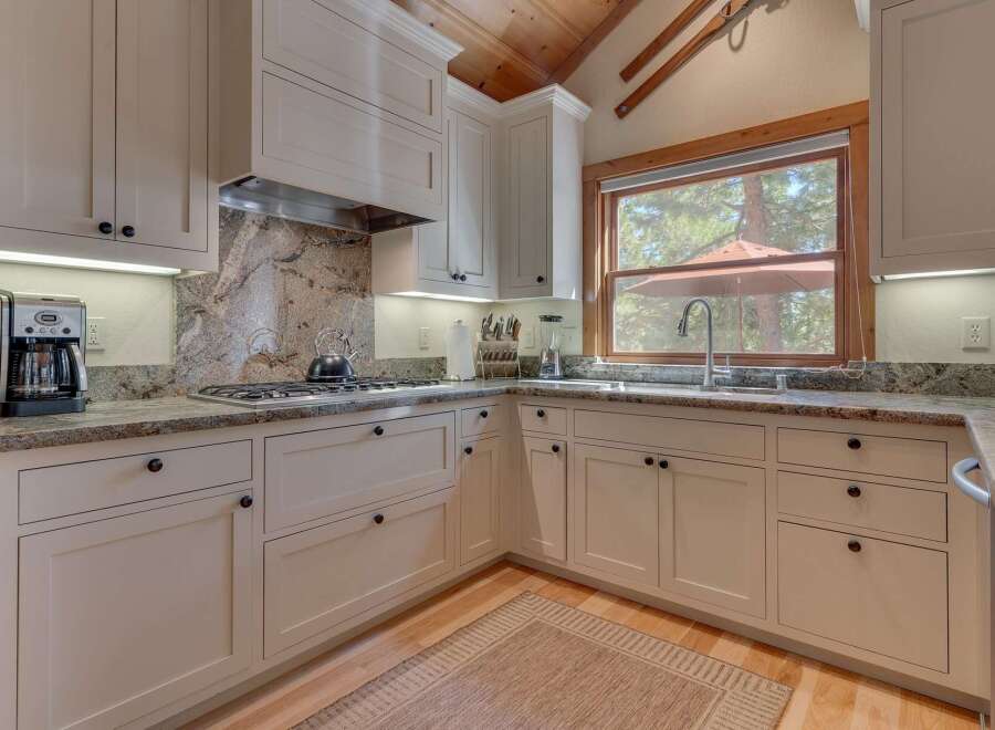 This stunning kitchen boasts custom cabinetry, granite countertops, and top-of-the-line appliances.