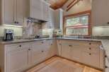 This stunning kitchen boasts custom cabinetry, granite countertops, and top-of-the-line appliances.