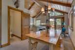 This stunning property boasts a rustic charm with its wooden vaulted ceilings and inviting dining area.