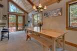 This stunning dining room features a beautiful wooden table and bench, perfect for family gatherings.