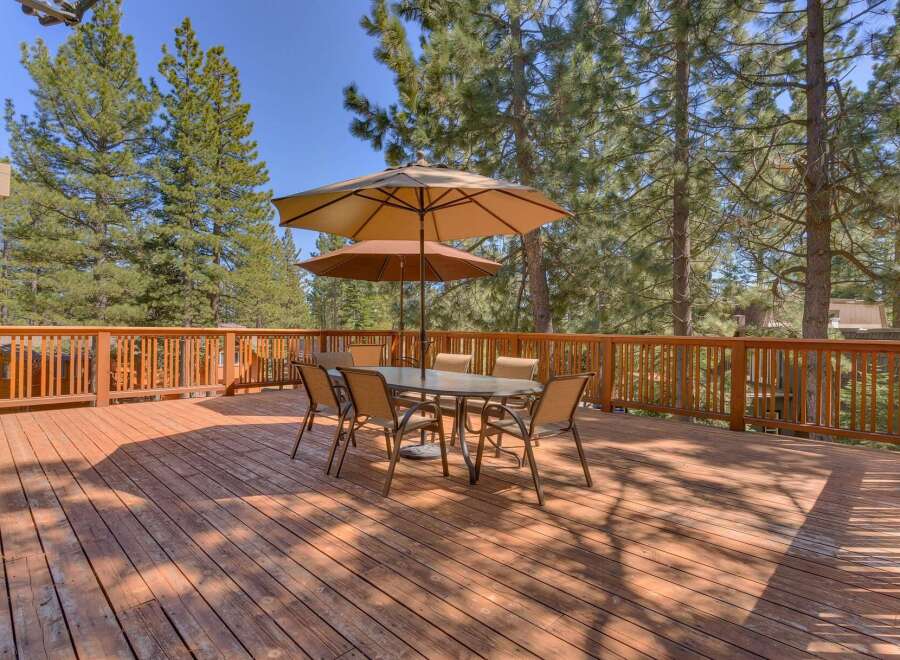 Enjoy outdoor living at its finest on this expansive wooden deck.