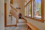 Step into this inviting entryway, featuring a charming staircase and a welcoming bear statue.