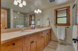 This stunning bathroom features a double vanity with a beautiful countertop and ample storage.