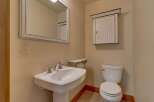 This charming bathroom features a classic pedestal sink, a pristine white toilet, and a stylish medicine cabinet.