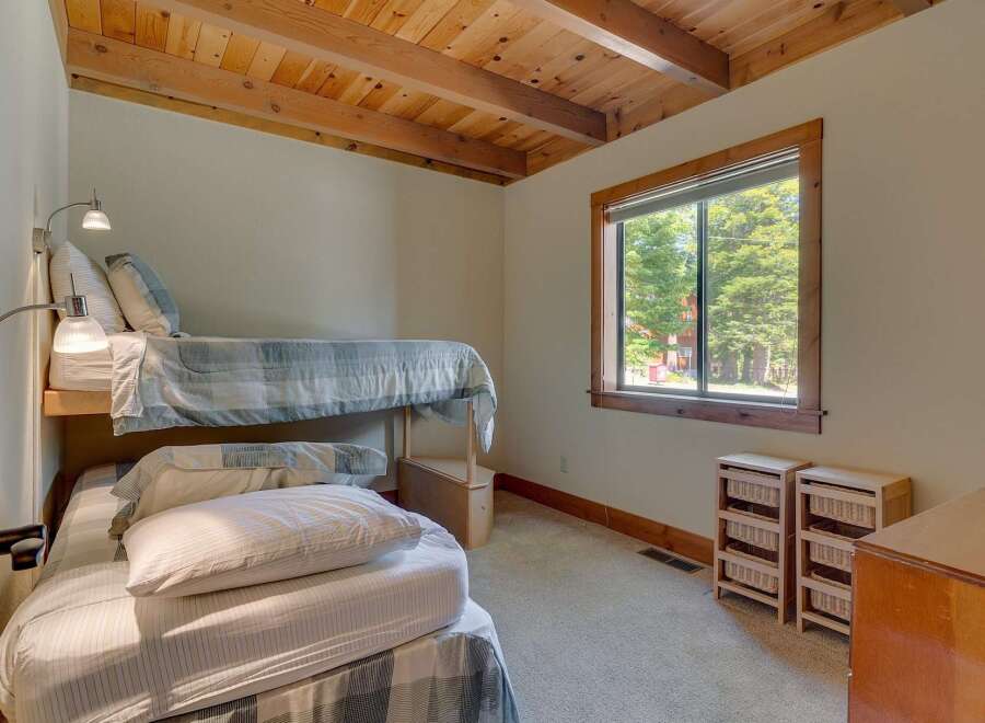 This charming bedroom features a unique bunk bed setup, perfect for maximizing space.