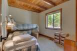 This charming bedroom features a unique bunk bed setup, perfect for maximizing space.
