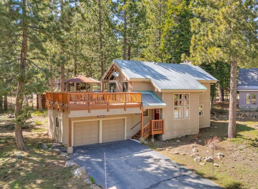 Nestled amidst towering trees, this charming home offers a serene escape.