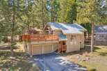 Nestled amidst towering trees, this charming home offers a serene escape.