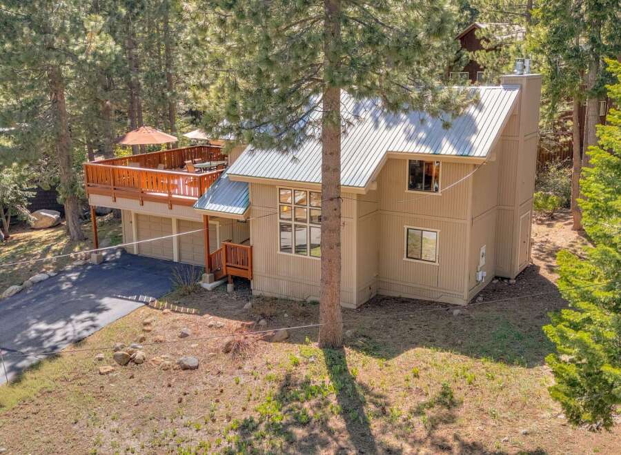 Nestled amidst towering trees, this stunning property offers a serene escape.