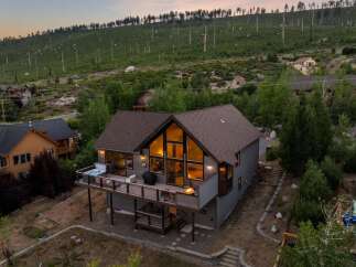 Discover your dream retreat in this stunning mountain home! This property boasts a spacious deck with a hot tub, perfect for enjoying breathtaking views.