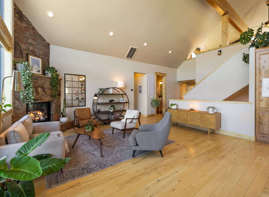 Step into luxury with this stunning property, showcasing a cozy living room with a stone fireplace, perfect for those chilly evenings.