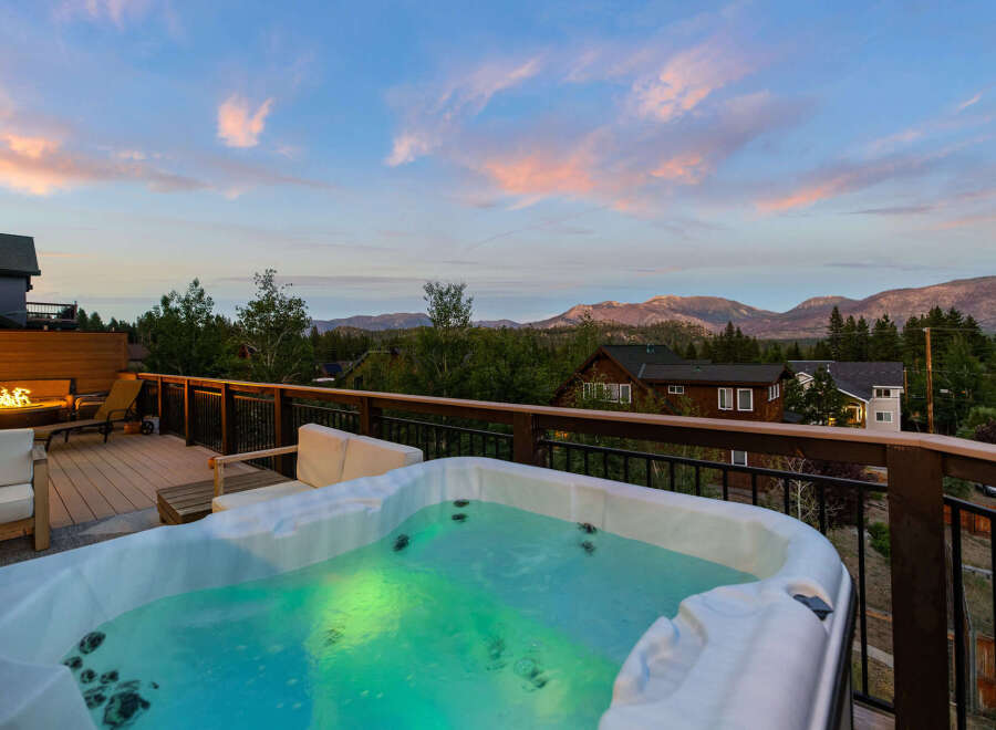 Enjoy breathtaking views from this luxurious property featuring a private hot tub, perfect for relaxing after a long day.