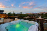 Enjoy breathtaking views from this luxurious property featuring a private hot tub, perfect for relaxing after a long day.