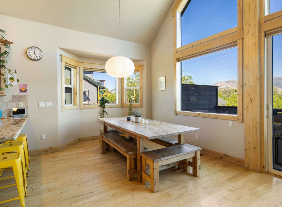 This stunning dining area boasts a rustic wooden table and benches, perfect for family gatherings.